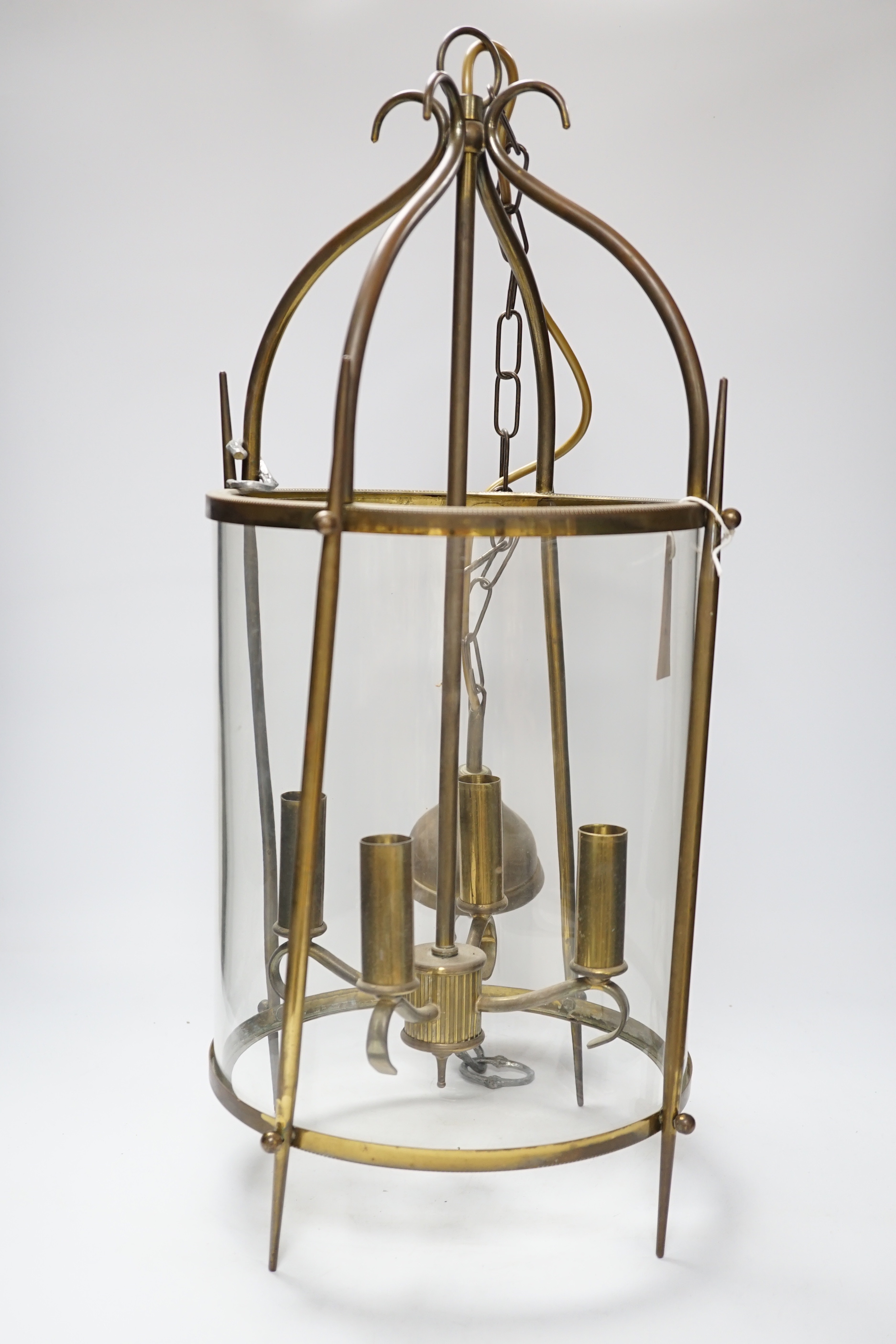 A circular brass and glass four light lantern 59cm high